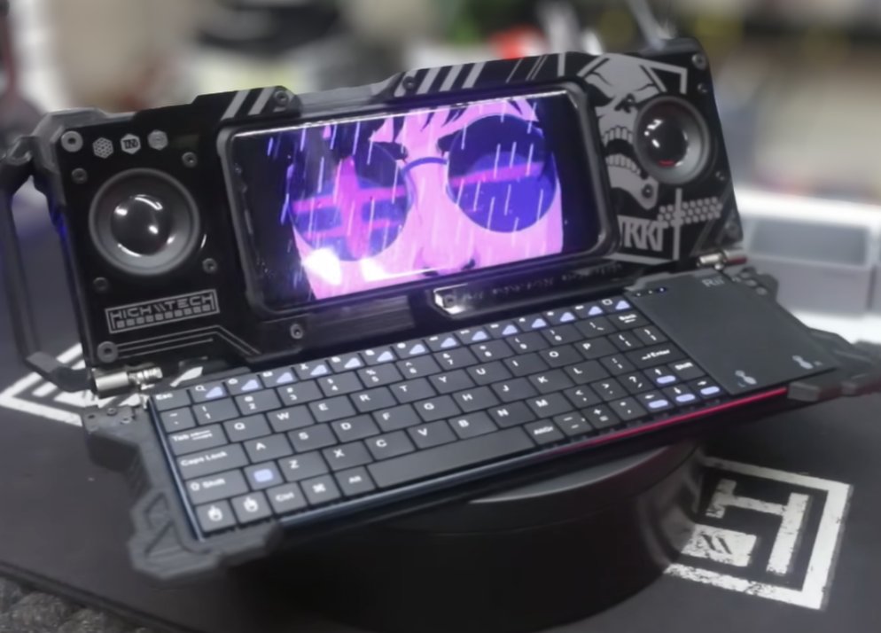 A ruggedised laptop-style cyberdeck with dual fans and a mechanical keyboard, glowing purple.